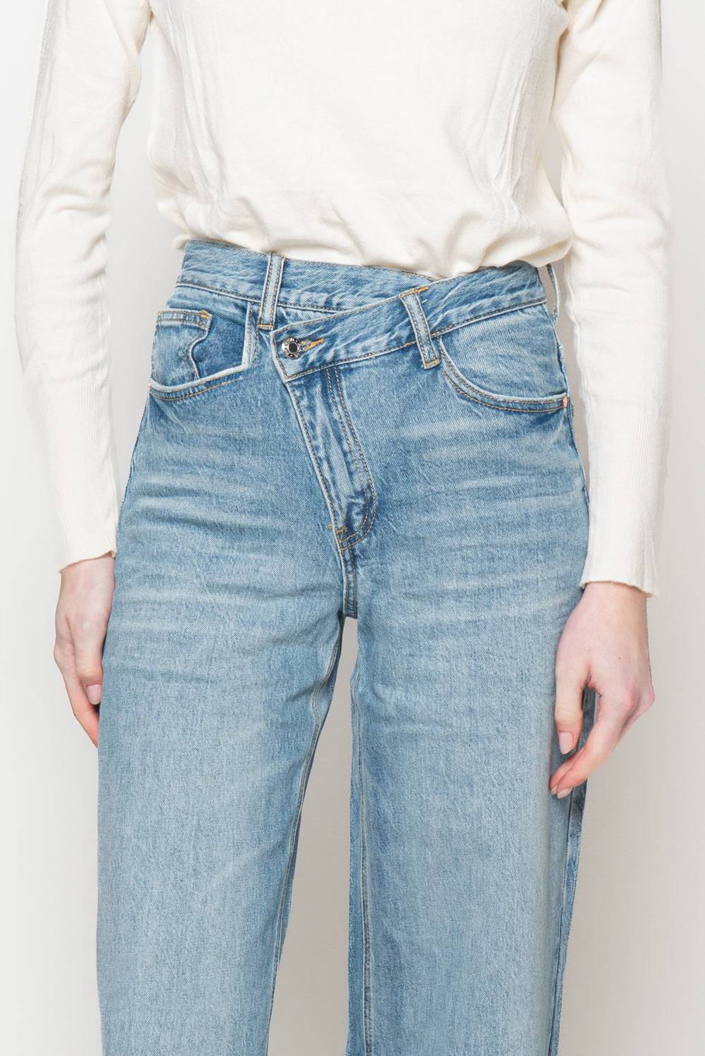 Jeans con bottone storto